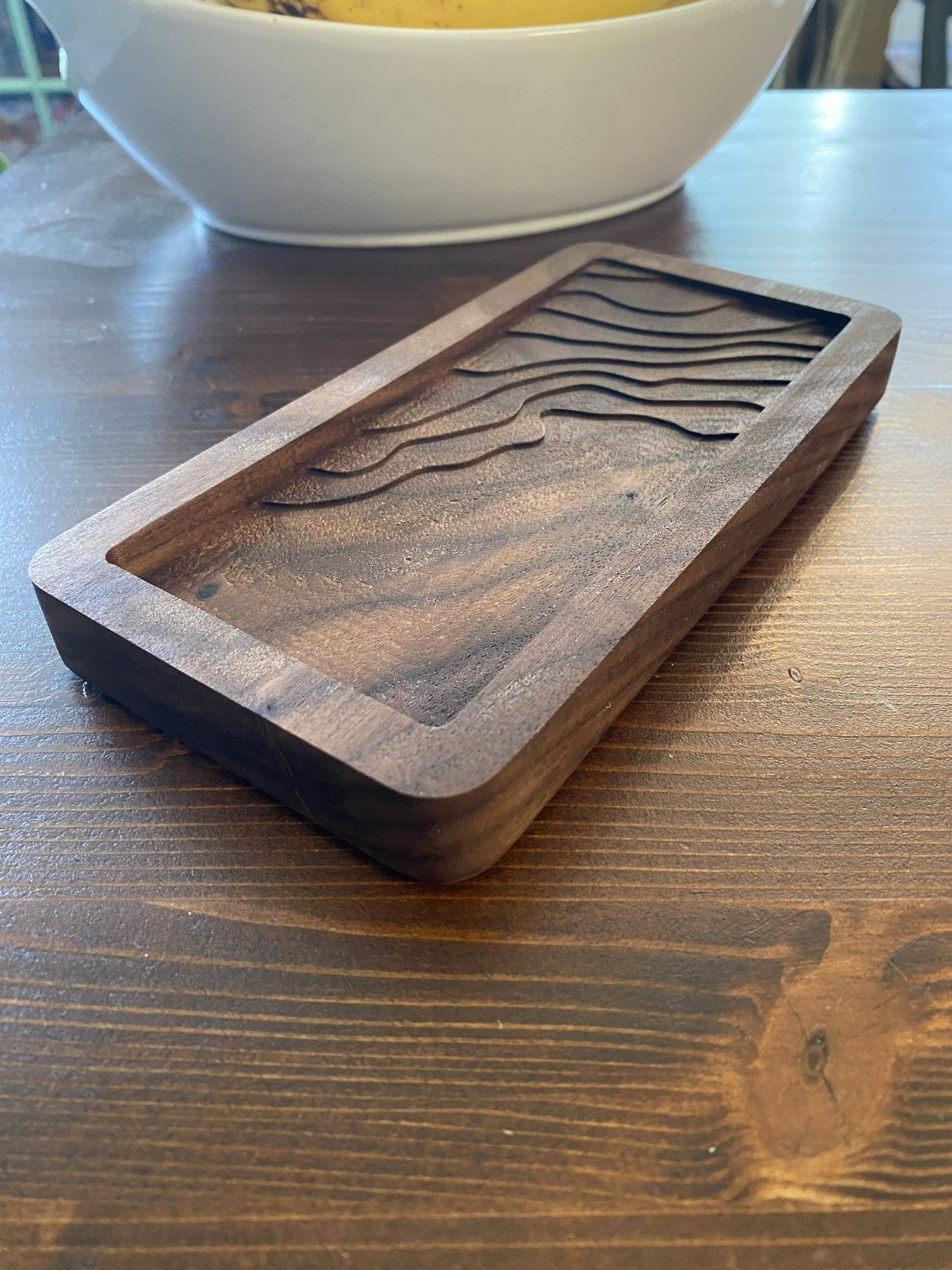 Rectangular catch tray with topographic details