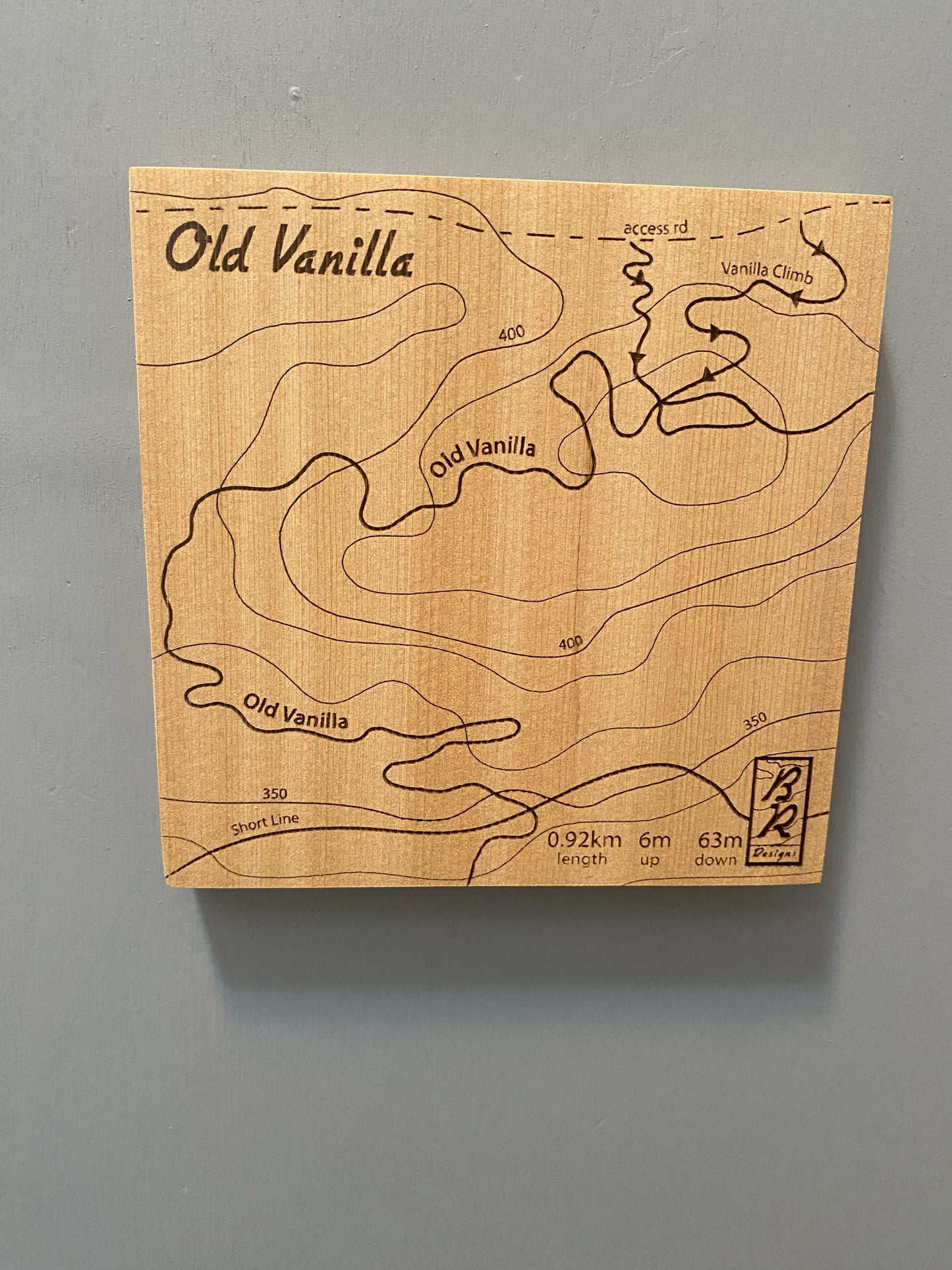 A wooden map tile featuring a detailed trail map of Old Vanilla in the Cumberland mountain bike trails.