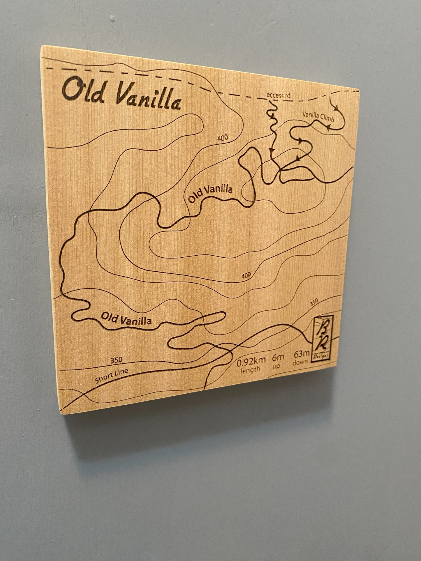 A wooden map tile featuring a detailed trail map of Old Vanilla in the Cumberland mountain bike trails.