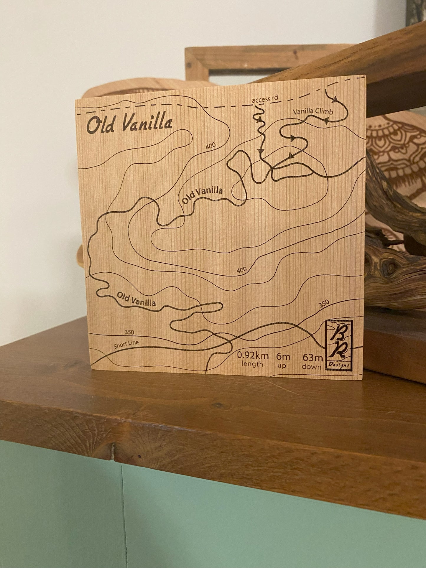 A wooden map tile featuring a detailed trail map of Old Vanilla in the Cumberland mountain bike trails.