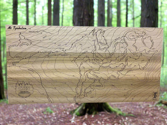 A Laser engraved map of the Mt. Tzouhalem mountain bike trail network, displayed against a natural outdoor background.