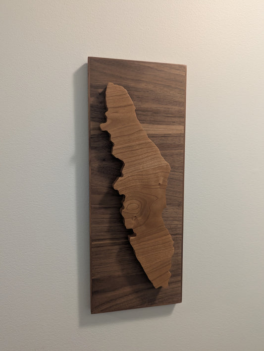 Wooden wall art with a cherry cut-out design of Vancouver Island on a walnut backer.