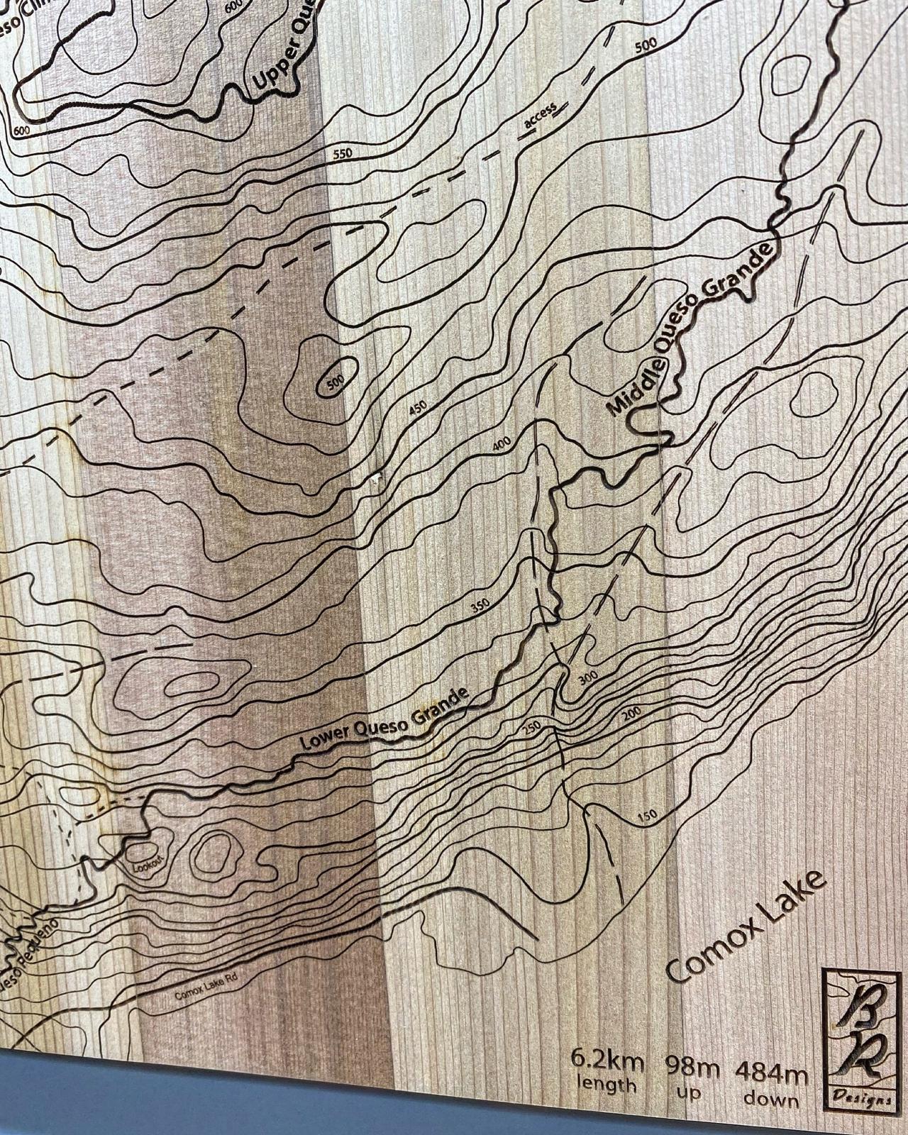 A close up of wooden map tile featuring a detailed trail map of The Queso's in the Cumberland mountain bike trails.