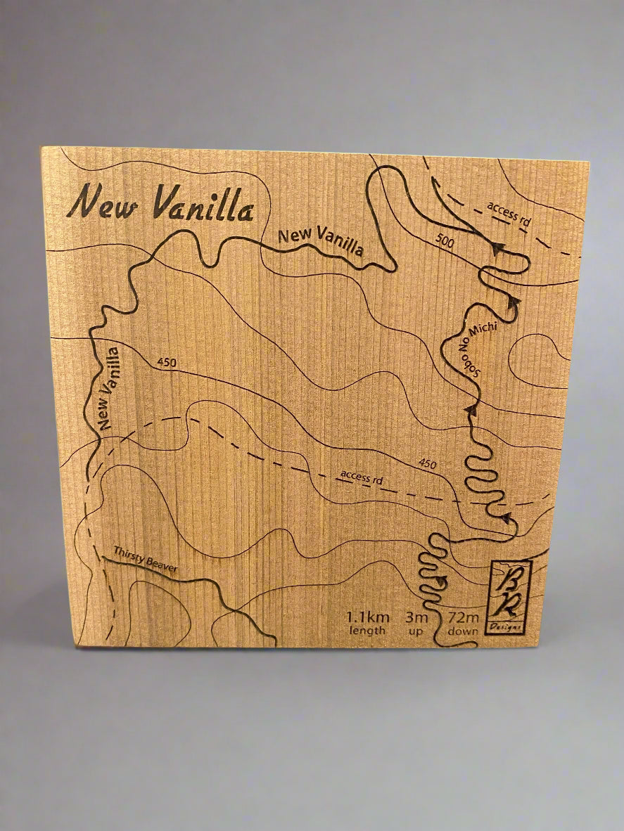A wooden map tile featuring a detailed trail map of New Vanilla in the Cumberland mountain bike trails.