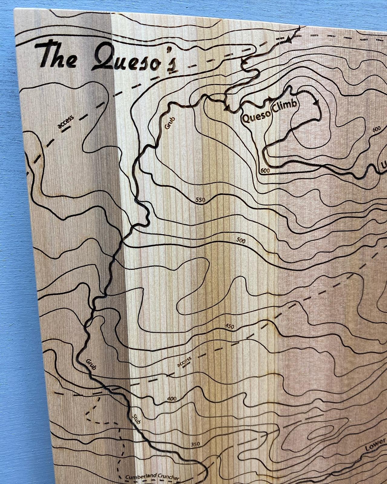A close up of wooden map tile featuring a detailed trail map of The Queso's in the Cumberland mountain bike trails.