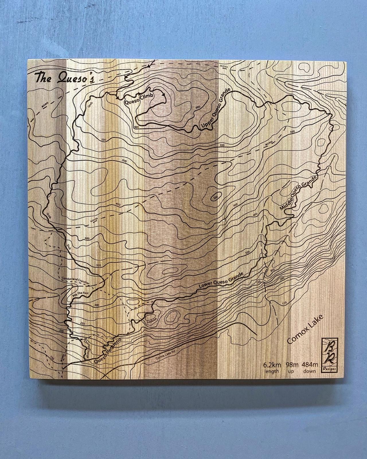 A wooden map tile featuring a detailed trail map of The Queso's in the Cumberland mountain bike trails.